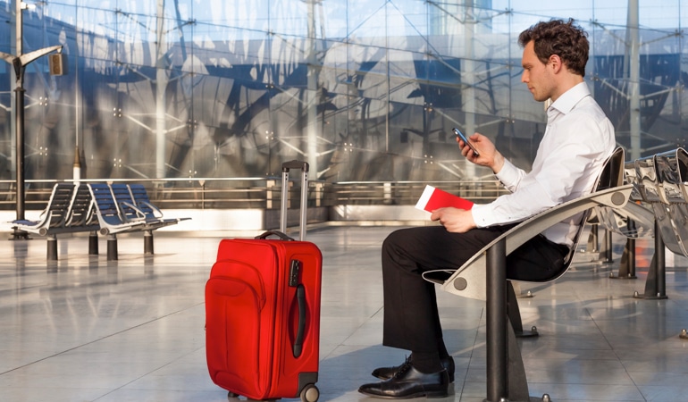 Traveling man is sitting on a bank ready for thrombosis prophylaxis